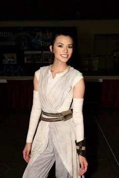 a woman in a star wars costume posing for the camera with her hands on her hips