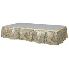 an image of a table cloth with flowers and leaves on the top, in various colors