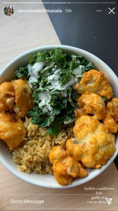 a white bowl filled with food on top of a wooden table