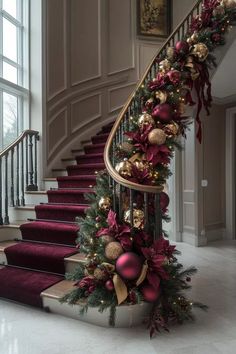 a staircase decorated for christmas with ornaments and garland on the bannister railings