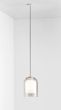 a light fixture hanging from the ceiling in a room with white walls and flooring