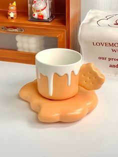 a cup and saucer sitting on top of a table next to a wooden box