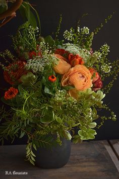 a vase filled with lots of flowers on top of a table