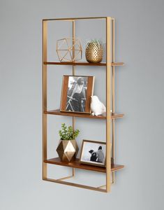 three shelves with pictures and vases on them