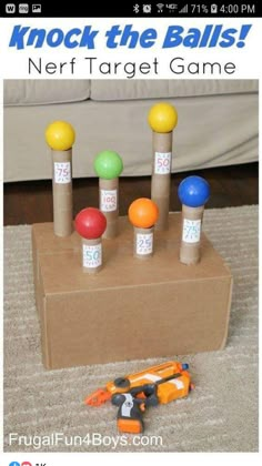 a cardboard box that has some balls on top of it and toys in front of it