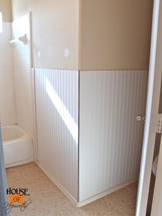 a bathroom with a shower stall and toilet in the corner, next to a bathtub