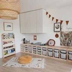 a living room filled with furniture and lots of storage space next to a wooden floor