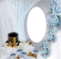 a white table topped with lots of blue flowers next to a round mirror on top of a curtain