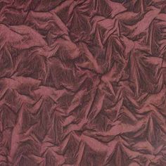 the texture of fabric is very dark red in color and it appears to be wrinkled