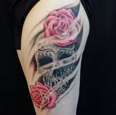 a woman's thigh with a skull and roses on it