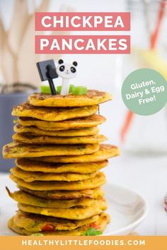 a stack of pancakes on a white plate with a panda bear figurine sticking out of the top