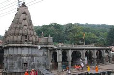 people are standing in front of an old temple