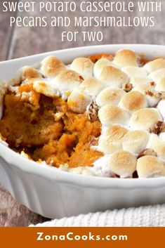 sweet potato casserole with pecans and marshmallows in a white dish