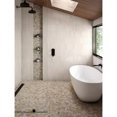 a large white bath tub sitting next to a shower in a bathroom under a wooden ceiling