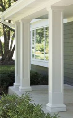 an image of a house with columns on the front porch and side yard in the background