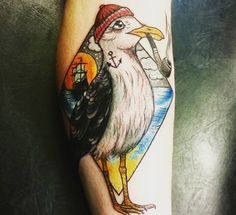 a bird with a red hat on it's head sitting on a person's leg