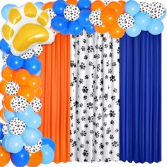 an orange, blue and white balloon arch with paw prints