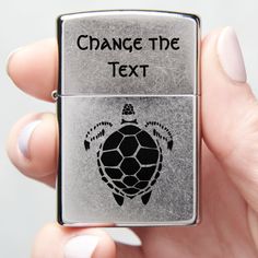 a person holding a zippo lighter with a turtle on it's side and the words change the text