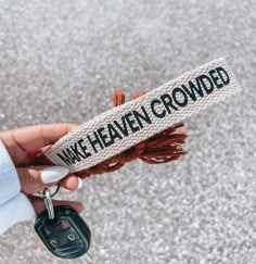 a person holding a car key in their left hand with the words wake haven grounded on it