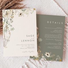 an open book with flowers on it sitting next to a furnishing material and a tassel