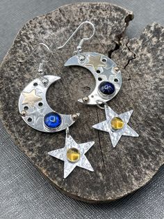 I've created these sparkly and fun-filled whimsical earrings in a celestial theme, featuring two 6mm round gemstones of your choosing. The gemstones have a glowing hue when turned in lighting and are reflective, luminous and magical! The moons are 1 and 1/4 inches in diameter and I've hand-cut two small 14K gold-filled stars and soldered them onto the moons, did the same with two sterling silver stars, and each earring has one 2mm solid 14K bead near the hooks.  The stars beneath are 1/2 inch in Whimsical Earrings, Celestial Theme, Crescent Moon And Star, Moon And Star Earrings, Bold Jewelry, Dope Jewelry, Small Jewelry Box, Celestial Jewelry, Moon And Star