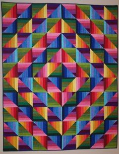 a colorful quilt is hanging on the wall