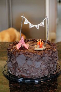 a chocolate cake sitting on top of a table next to an orange and white flag