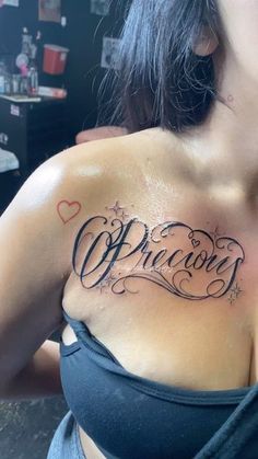 a woman with a tattoo on her chest that reads, overcome and the word love is written in cursive writing