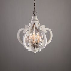 a white chandelier hanging from a ceiling