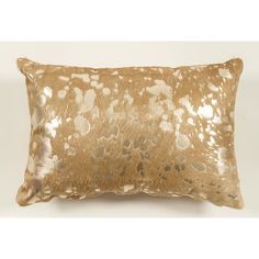 an animal print pillow with gold foil on it's back and white spots in the front