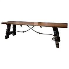 an iron and wood bench with two legs