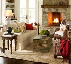 a living room filled with furniture and a fire place in the middle of the room