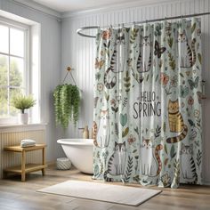 the shower curtain is decorated with cats and plants in green colors, along with a white bathtub