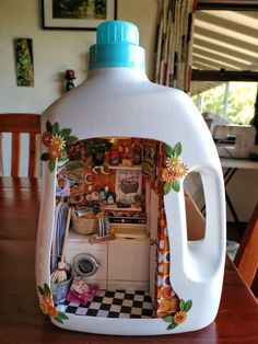 a plastic jug with an image of a kitchen in it on top of a wooden table