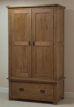 a large wooden armoire with two drawers