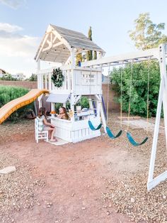 a child's play area with a swing set and slide