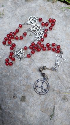 Rosario vintage rigenerato di vetro rosso a tema Lucifero e Lilith. Potrebbe presentare segni del tempo.  Vintage regenerated rosary with pentacles and Lucifer + Lilith sigils, made with red glass beads. Being vintage, it could show some imperfections. Red Vintage 8mm Bead Necklaces, Vintage Red 8mm Beaded Jewelry, Red Vintage Necklaces With 8mm Beads, Vintage Red Jewelry With 8mm Beads, Red Vintage Necklace With 8mm Beads, Handmade Red Rosary For Jewelry Making, Red 8mm Beaded Festival Jewelry, Red 8mm Beaded Jewelry For Festivals, Red Beaded Jewelry For Festivals