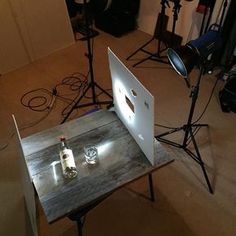 an open laptop computer sitting on top of a wooden table in front of a camera