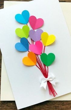 some paper hearts are attached to a card