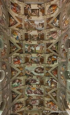 the ceiling is painted with many different paintings