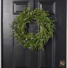 a wreath is hanging on the front door