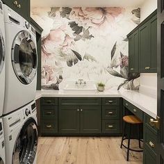 a washer and dryer in a room with floral wallpaper on the walls