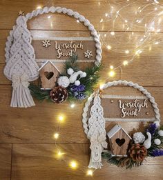 two christmas decorations made out of wood and rope on a wooden floor with lights in the background