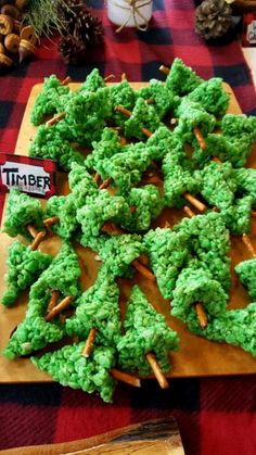 some green food is on a cutting board and there are pine cones in the middle