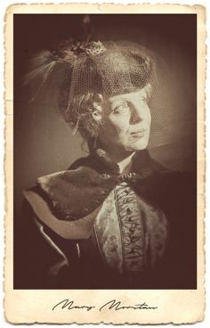 an old photo of a woman with a veil on her head and hair in a bun