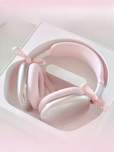 a pair of pink headphones in a white box