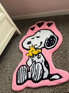 a rug with a cartoon dog holding a star on the floor next to a dresser