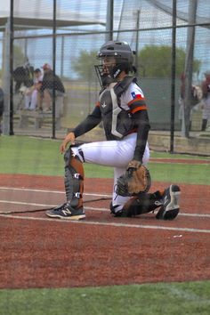 a baseball player kneeling down on the field