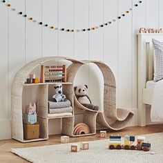 a child's bedroom with white walls and wooden flooring is decorated in neutral tones