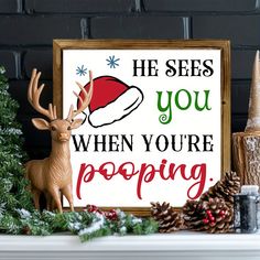 a sign that says he sees you when you're pooping next to a christmas tree